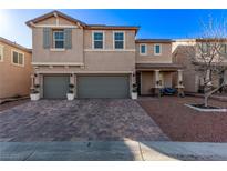 Two-story house with three-car garage and landscaped front yard at 7131 Rosecrans St, Las Vegas, NV 89166