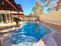 Inviting kidney-shaped pool with spa and covered patio at 865 Gleamstar Ave, Las Vegas, NV 89123