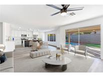 Open living room showcasing a kitchen, pool view, and modern furniture at 9541 Summersweet Ct, Las Vegas, NV 89123