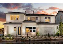 Two-story home with light-colored siding, stone accents, and landscaping at 10130 Sequoia Glen Ave, Las Vegas, NV 89166