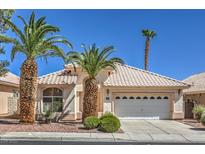 Single-story house with tile roof, palm trees, and a two-car garage at 2149 Eaglepath Cir, Henderson, NV 89074