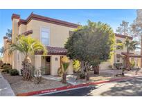 Two-story townhome with Spanish-style architecture and landscaping at 2801 N Rainbow Blvd # 258, Las Vegas, NV 89108