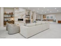 Spacious living room featuring a marble fireplace and modern decor with an open floor plan at 3104 Conners Dr, Las Vegas, NV 89107