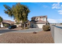 Two-story house with attached garage and desert landscaping at 5982 Clover Canyon Ln, Las Vegas, NV 89142