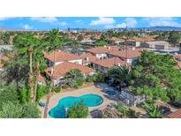 Aerial view of community pool, and complex with city views at 6711 W Charleston Blvd # 4, Las Vegas, NV 89146