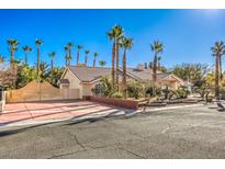 Single-story house with palm trees and a large driveway at 7755 Coley Ave, Las Vegas, NV 89117