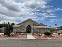 Single-story home with attractive landscaping and a large driveway at 121 E Cypress Dr, Henderson, NV 89015