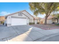 House exterior featuring a two-car garage and well-maintained landscaping at 4536 Rolls Royce Rd, North Las Vegas, NV 89031