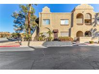 Tan two-story building with arched entryways and a staircase at 5101 Pioneer Ave # 101, Las Vegas, NV 89146