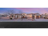 Beautiful one-story home with stone accents and a three-car garage at 7670 Frittata Ave, Las Vegas, NV 89113