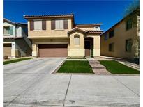 Two-story house with a brown garage door and artificial turf at 1908 W Hammer Ln, North Las Vegas, NV 89031