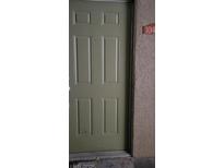 Well-maintained light green front door with number 104 at 2101 Blue Breeze Dr # 104, Las Vegas, NV 89128