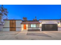 Charming single-story home featuring a mix of modern and rustic design elements with stone accents and a tile roof at 2500 W Oakey Blvd, Las Vegas, NV 89102