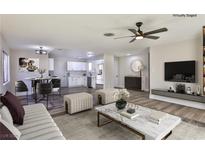 Bright living room with hardwood floors, stylish furniture, and large windows at 3225 Crawford St, North Las Vegas, NV 89030