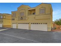 Tan two-story townhome with three-car garage and private entrance at 3929 Pepper Thorn Ave # 101, North Las Vegas, NV 89081