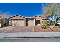 Single-story home with three-car garage and landscaped front yard at 5170 Agio Ave, Pahrump, NV 89061