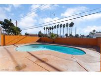 Kidney-shaped swimming pool with surrounding concrete patio at 5453 Requa Ave, Las Vegas, NV 89110