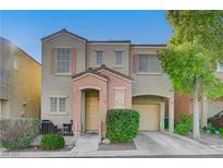 Two-story house with beige exterior, peach accents, and a two-car garage at 6285 Crusted Dome Ct, Las Vegas, NV 89139