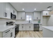 Modern kitchen with stainless steel appliances and white shaker cabinets at 647 Greenbriar Townhouse Way, Las Vegas, NV 89121