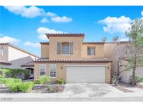 Two-story house with beige exterior, shutters, and a two-car garage at 7490 Thistle Poppy St, Las Vegas, NV 89139