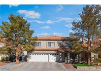 Two-story house with a three-car garage and landscaping at 8600 Copper Falls Ave, Las Vegas, NV 89129