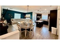Bright, open-concept living space with modern light fixture and neutral furnishings at 965 Nevada State Dr # 1202, Henderson, NV 89002