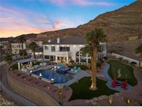 Luxury home with pool and putting green; sunset view at 1610 Hardrock St, Las Vegas, NV 89156