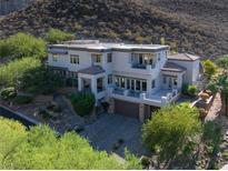 Stunning multi-story home featuring a desert landscape and a neutral color palette at 1635 Liege Dr, Henderson, NV 89012