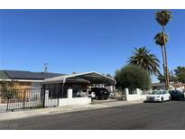 Single story home with carport, solar panels, and fenced yard at 3712 San Joaquin Ave, Las Vegas, NV 89102