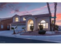 Two-story house with a three-car garage and landscaped front yard at 3925 Larkcrest St, Las Vegas, NV 89129