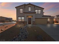 Two-story house with tan siding, stone accents, and a three-car garage at 3981 E Teller Dr, Pahrump, NV 89061