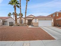 Single-story house with desert landscaping and a two-car garage at 414 Maritocca Ave, North Las Vegas, NV 89031