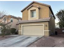 Tan two-story house with attached garage and landscaping at 5066 El Castano Ave, Las Vegas, NV 89108