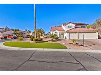 Two-story house with landscaped yard, driveway, and attached garage at 5112 Palm View Dr, Las Vegas, NV 89130