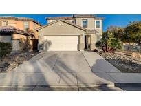 Two-story house with a large driveway and desert landscaping at 6104 Talbot Springs Ct, North Las Vegas, NV 89081