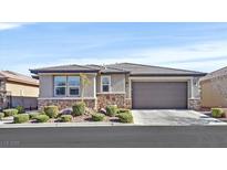 Single-story house with a two-car garage and landscaped front yard at 6914 Willowcroft St, Las Vegas, NV 89149