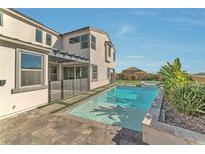 Beautiful backyard pool with stone patio and luxurious landscaping at 8224 Skye Territory St, Las Vegas, NV 89166