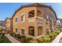 Tan two-story building with multiple units, walkways, and landscaping at 8985 S Durango Dr # 2047, Las Vegas, NV 89113