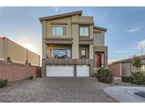 Modern three-story home with two-car garage and landscaped front yard at 9045 Knots Estate St, Las Vegas, NV 89139