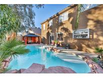 Inviting backyard oasis with a sparkling pool, gazebo, and lush landscaping at 9131 Sangria Ln, Las Vegas, NV 89147