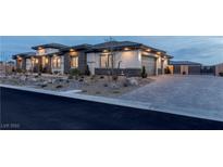 Beautiful single-story home featuring stone accents, manicured landscaping, and a paved driveway at 9525 Ponderay Ct, Las Vegas, NV 89149