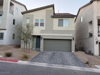 Two-story house with gray siding, gray garage door, and paved driveway at 10411 Rose Palisade St, Las Vegas, NV 89141