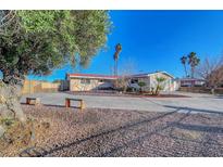 Ranch style home with a large front yard, long driveway and mature trees at 1401 S 17Th St, Las Vegas, NV 89104