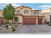 Two-story house with a three-car garage and landscaped front yard at 1557 Mistywood Ct, Henderson, NV 89014