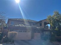 Two-story house with stone accents and a three-car garage at 2321 Martinique Ave, Henderson, NV 89044