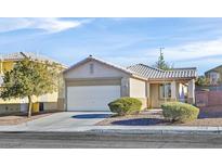 One-story house with a two-car garage and well-manicured front yard at 2687 Hollowvale Ln, Henderson, NV 89052