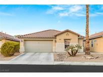 Single-story home with a two-car garage and desert landscaping at 3028 Gannon Ridge Ave, North Las Vegas, NV 89081