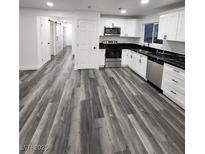 Modern kitchen with white cabinets, stainless steel appliances, and granite countertops at 4231 E Kellogg Rd, Pahrump, NV 89061