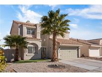 Two-story house with a green garage door and desert landscaping at 5458 Walton Heath Ave, Las Vegas, NV 89142