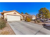 House exterior features a front yard, driveway, and two-car garage at 5608 Port Barrington Way, Las Vegas, NV 89130